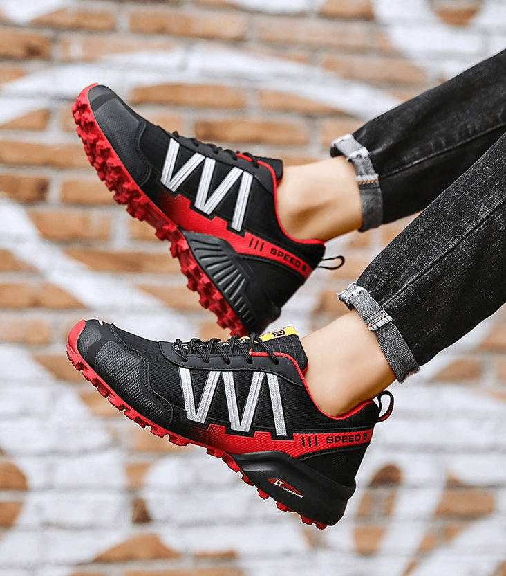 Black and red waterproof non-slip men's sneakers in action against brick wall background, perfect for sports and casual wear